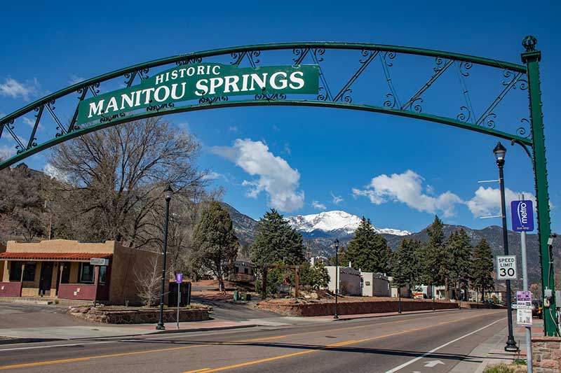 Image showing the Historic Manitou Springs Arch against a blue sky, which is seen as you enter the Gateway to Manitou Springs. Image showing the Historic Manitou Springs Arch against a blue sky, which is seen as you enter the Gateway to Manitou Springs.