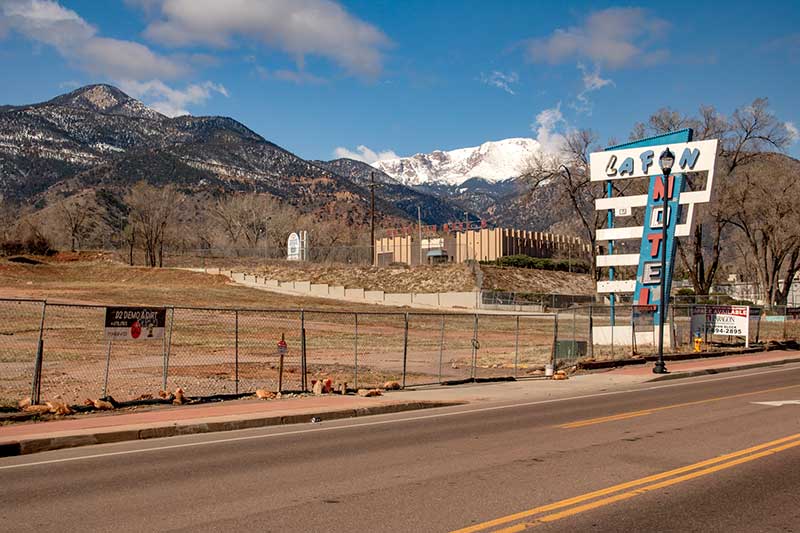 This photo shows the old La Fun Motel sign in an empty lot with Pikes Peak in the background. Success Stories from the Manitou Springs Urban Renewal Authority. This photo shows the old La Fun Motel sign in an empty lot with Pikes Peak in the background. Success Stories from the Manitou Springs Urban Renewal Authority.