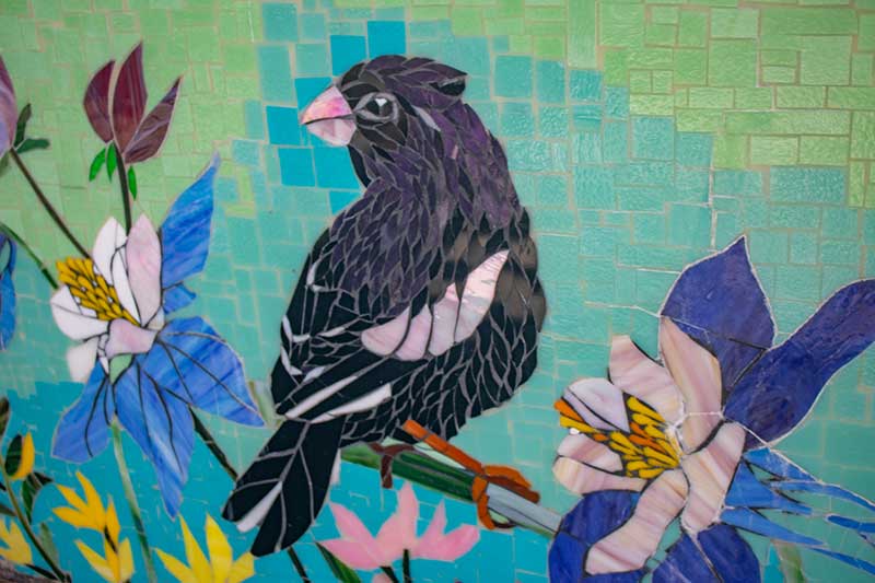 This photo shows the Marcy Morrison Bridge with the new art mosaic across the sides. Success Stories from the Manitou Springs Urban Renewal Authority. This photo shows the Marcy Morrison Bridge with the new art mosaic across the sides. Success Stories from the Manitou Springs Urban Renewal Authority.