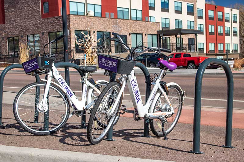 This photo shows the Pike Ride electric bikes along the avenue Manitou Springs Urban Renewal Authority Success Stories. This photo shows the Pike Ride electric bikes along the avenue Manitou Springs Urban Renewal Authority Success Stories.