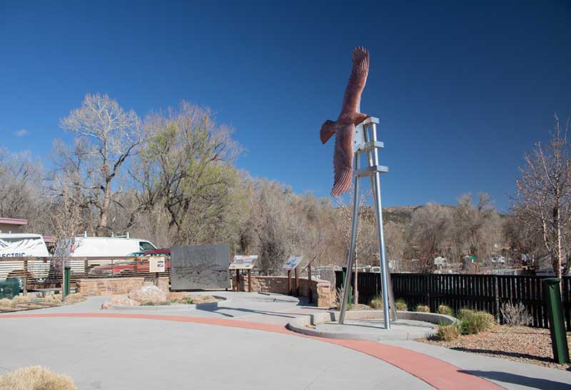 This is Soaring Eagle, a sculpture made from Rocky Mountain granite. It is an eagle in flight against a blue sky. Manitou Springs Urban Renewal Authority Success Stories. This is Soaring Eagle, a sculpture made from Rocky Mountain granite. It is an eagle in flight against a blue sky. Manitou Springs Urban Renewal Authority Success Stories.